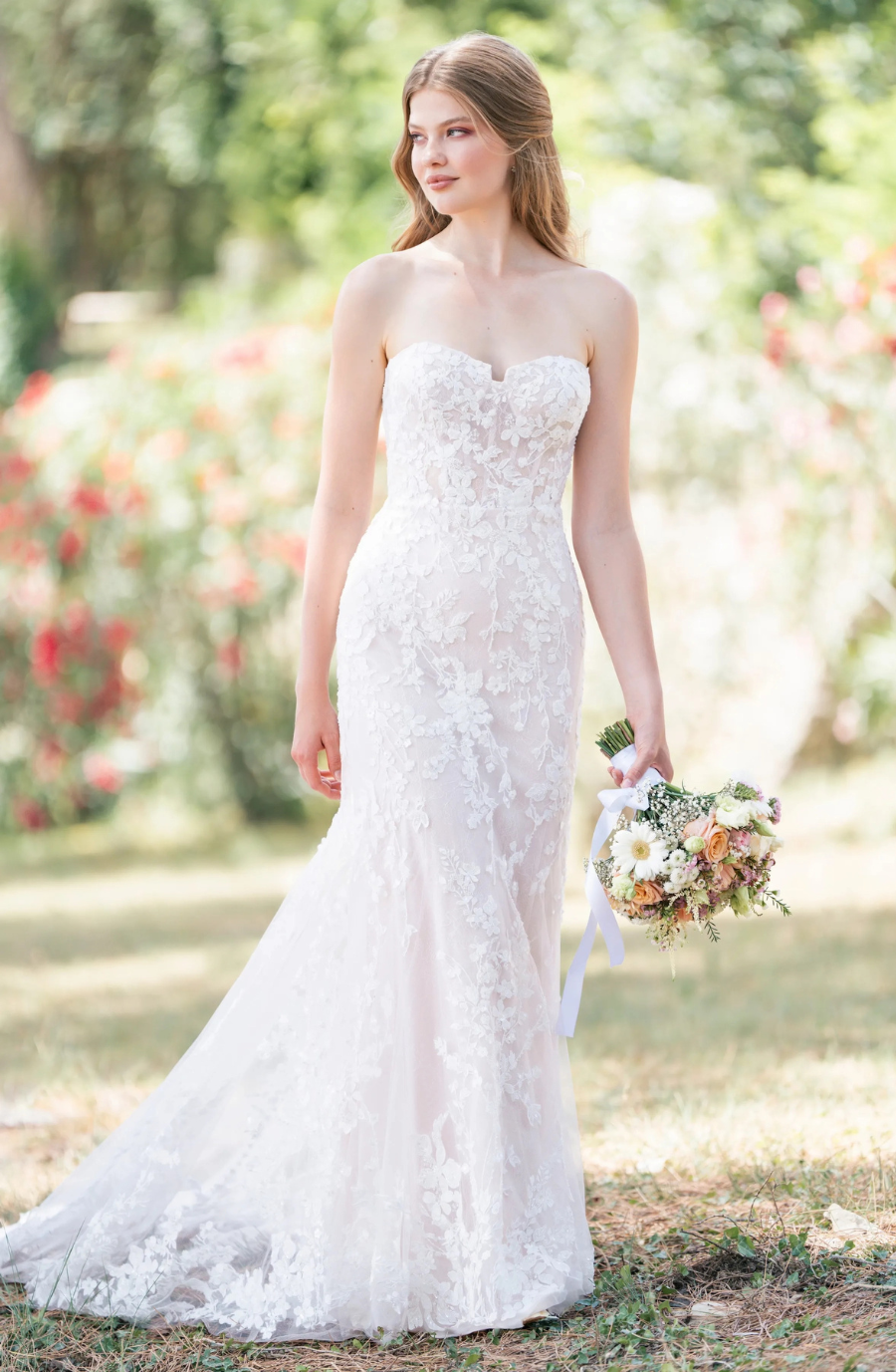 Model is wearing a strapless lace wedding gown by allure romance 