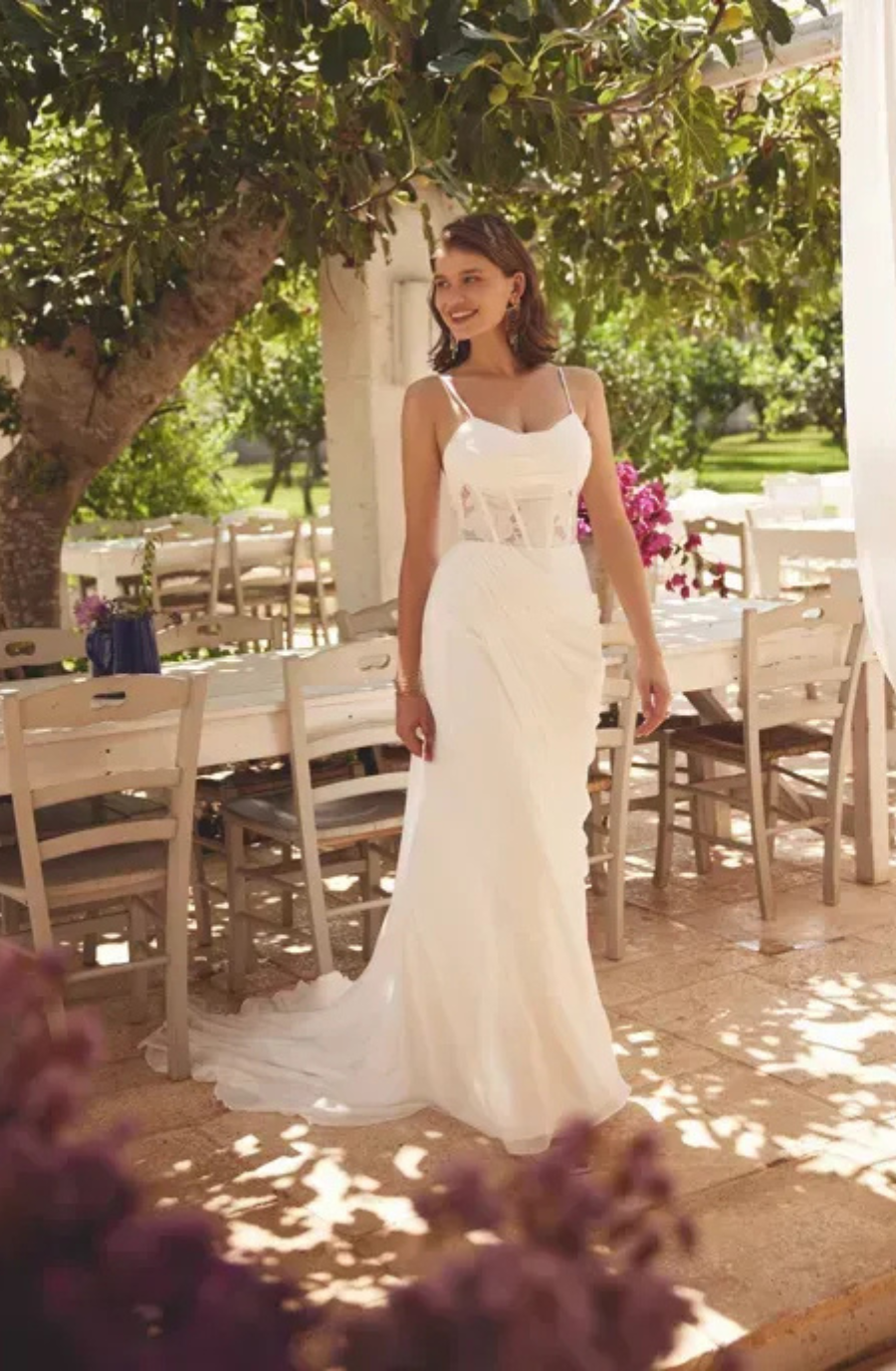 model is wearing a sleeveless chiffon a-line wedding dress