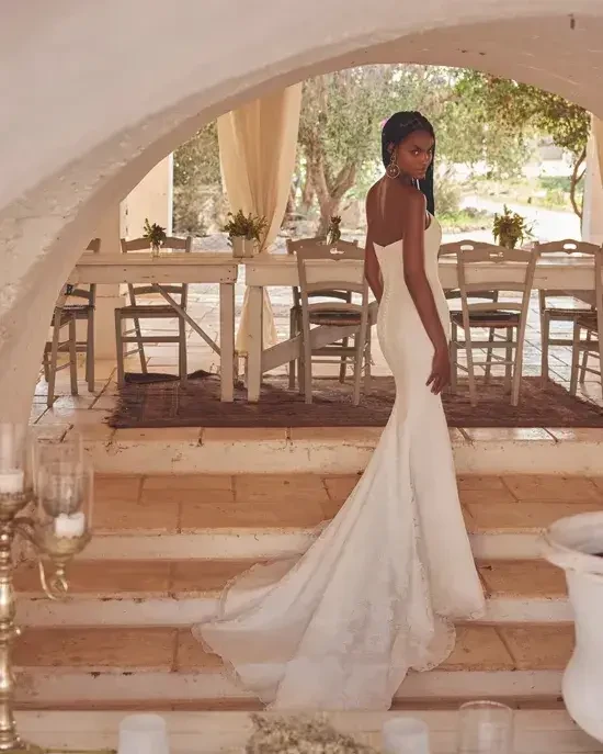 Model is wearing a strapless fit and flare wedding dress