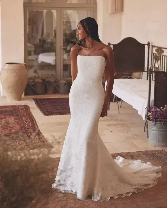 Model is wearing a strapless fit and flare wedding dress