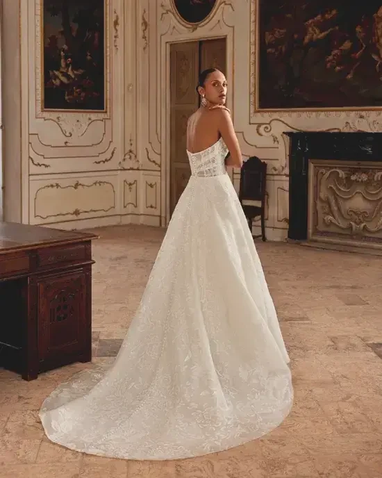 Model is wearing a strapless a-line lace wedding gown