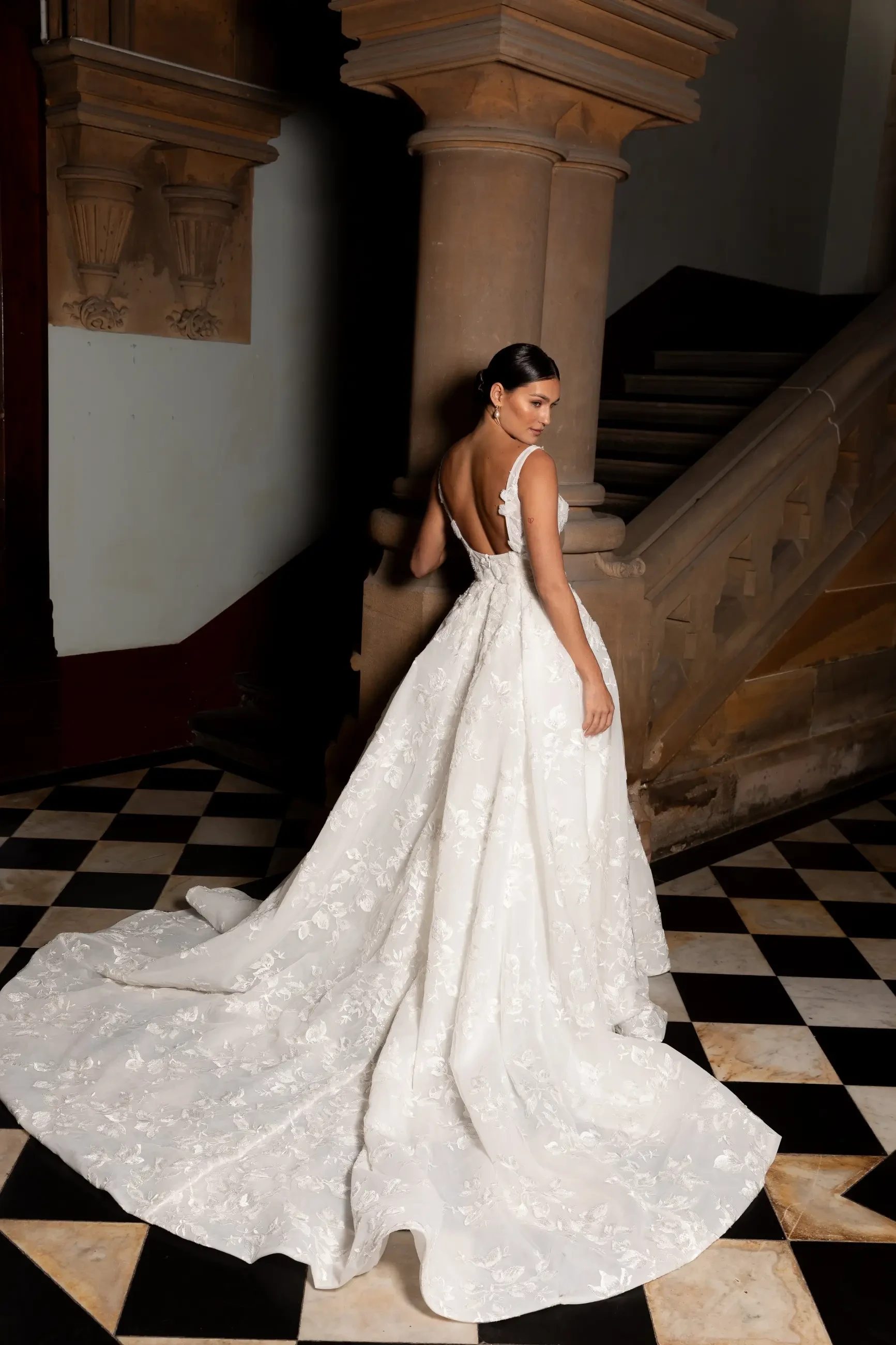 model is wearing a strapless ball gown wedding dress