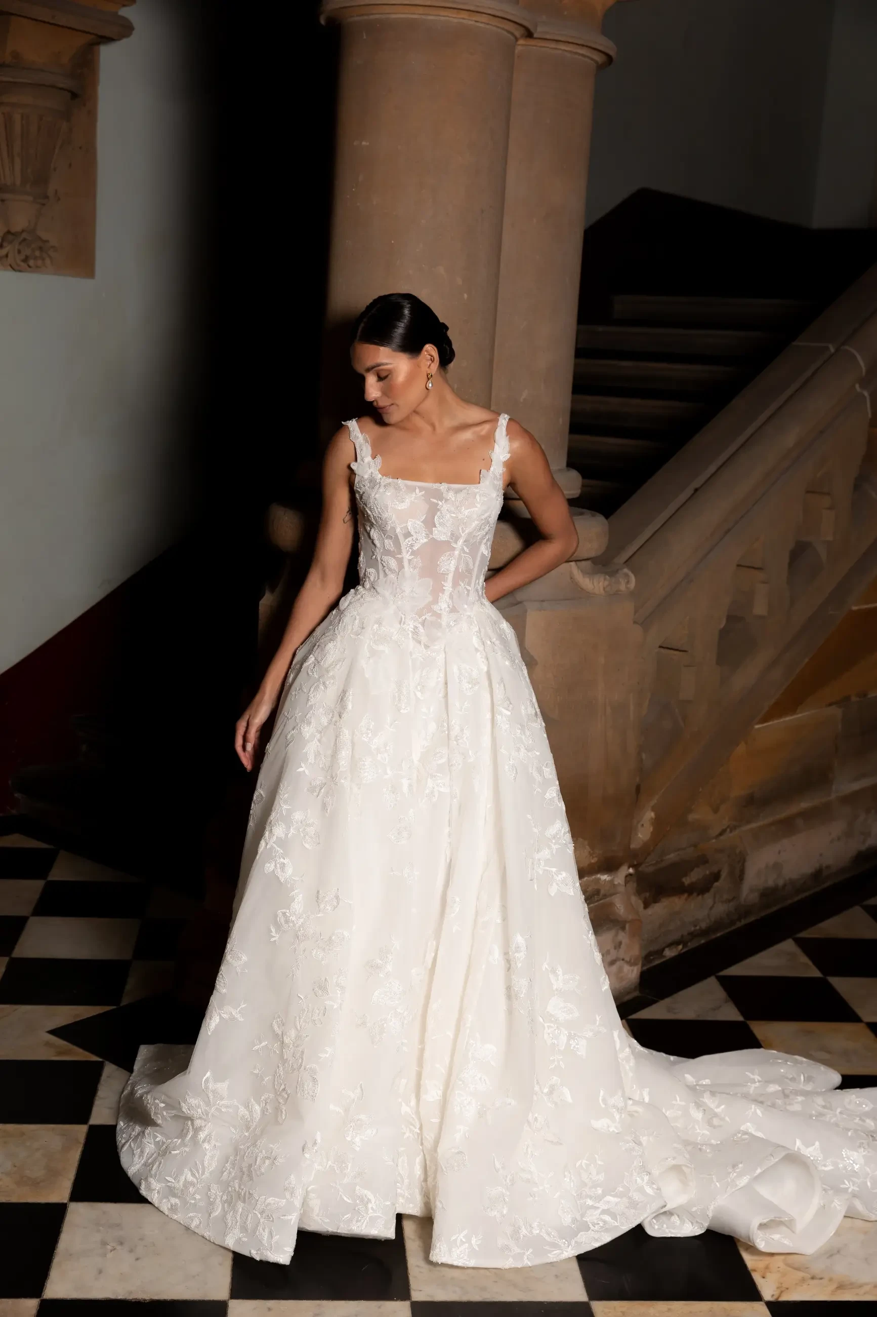 model is wearing a strapless ball gown wedding dress