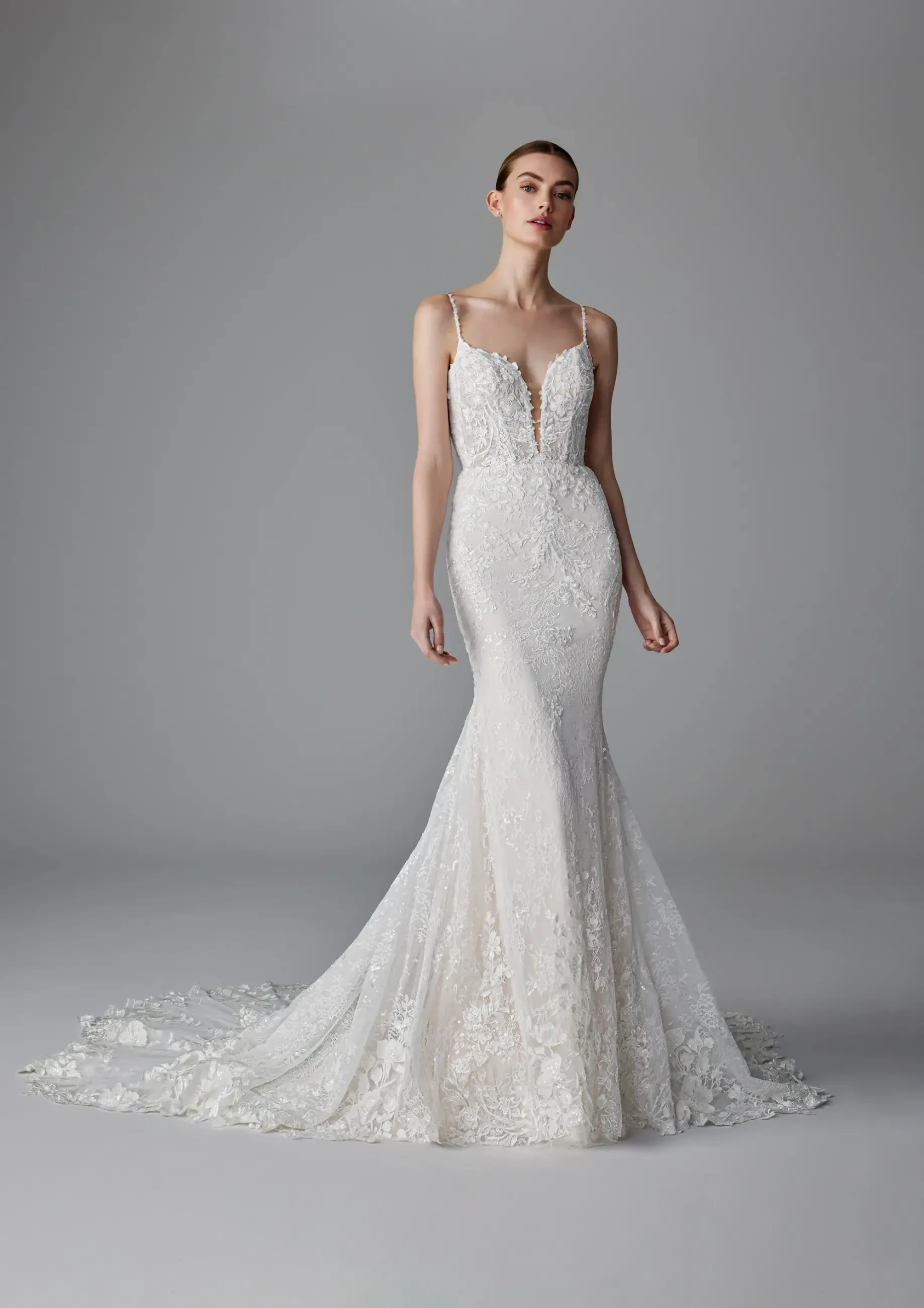 model is wearing a sleeveless lace fit and flare wedding dress