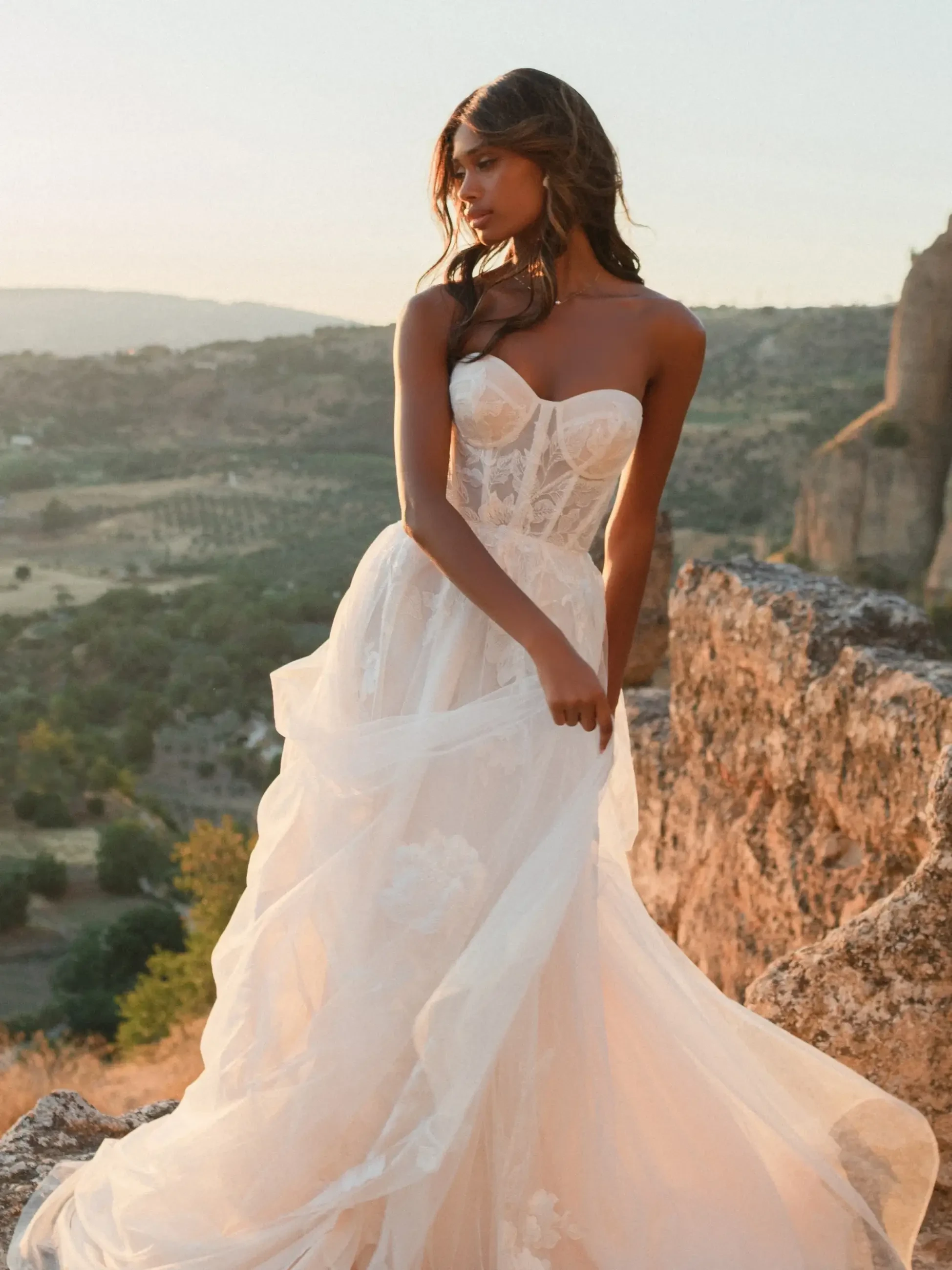 model is wearing a strapless sweetheart a-line wedding dress