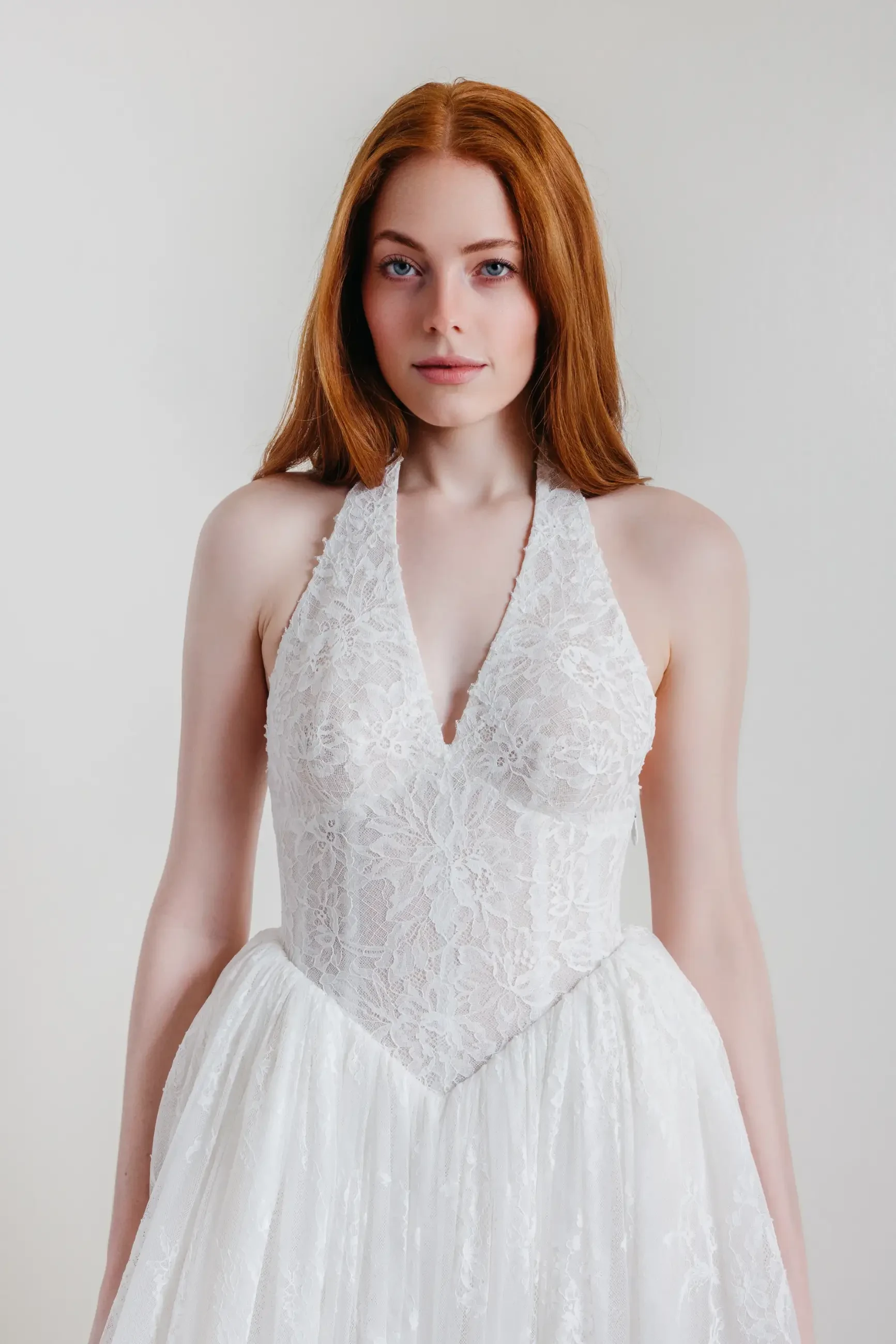 model is wearing a halter a-line wedding dress