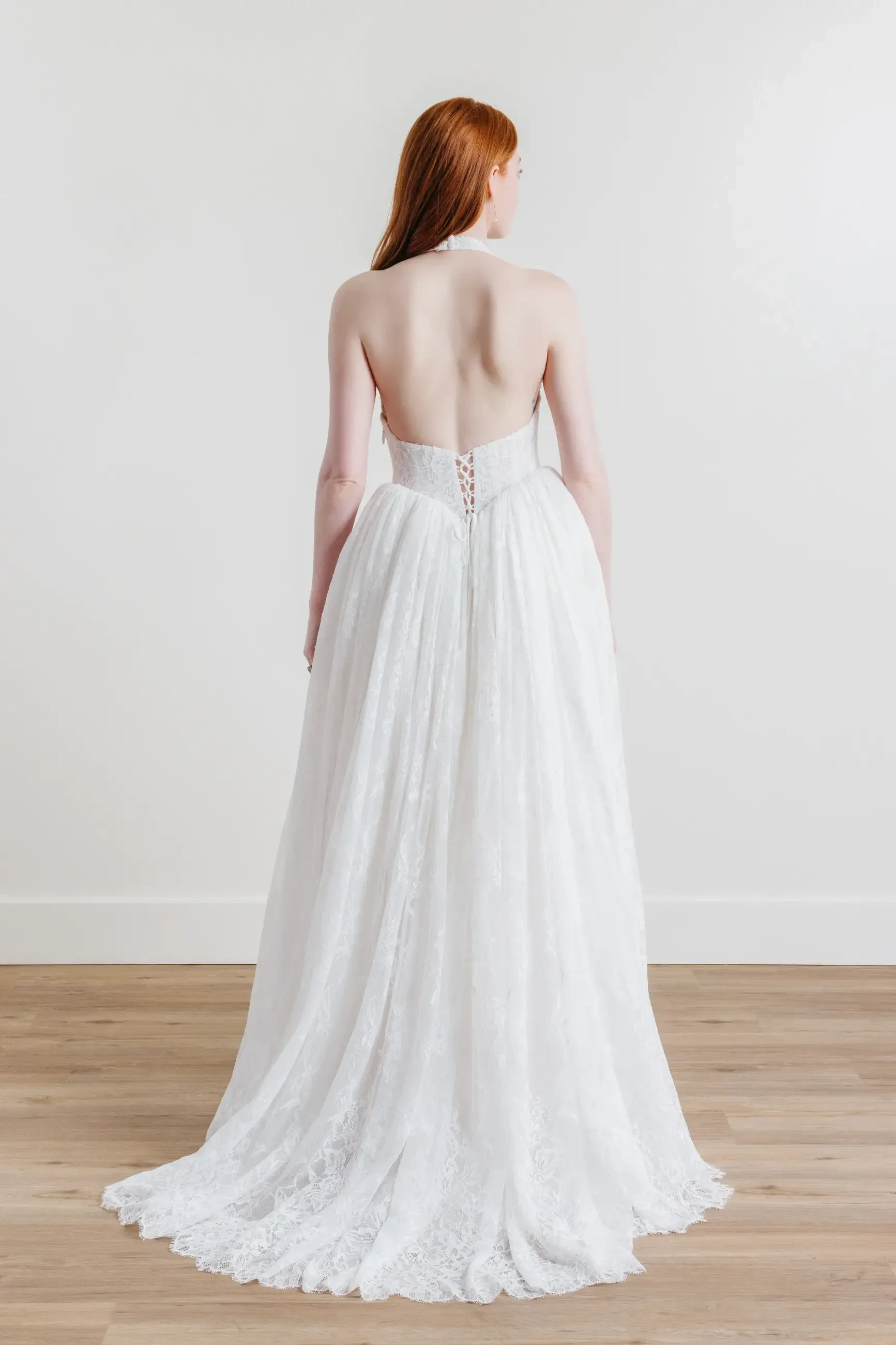 model is wearing a halter a-line wedding dress