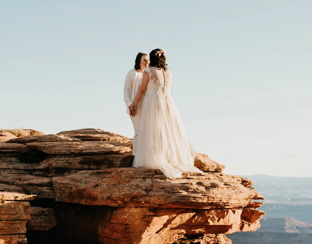 Сouple wearing a white gown and a white suit